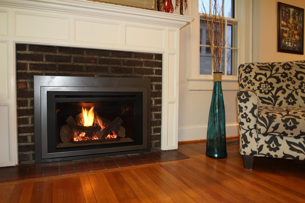 Living room remodeled gas fireplace with dark bricks