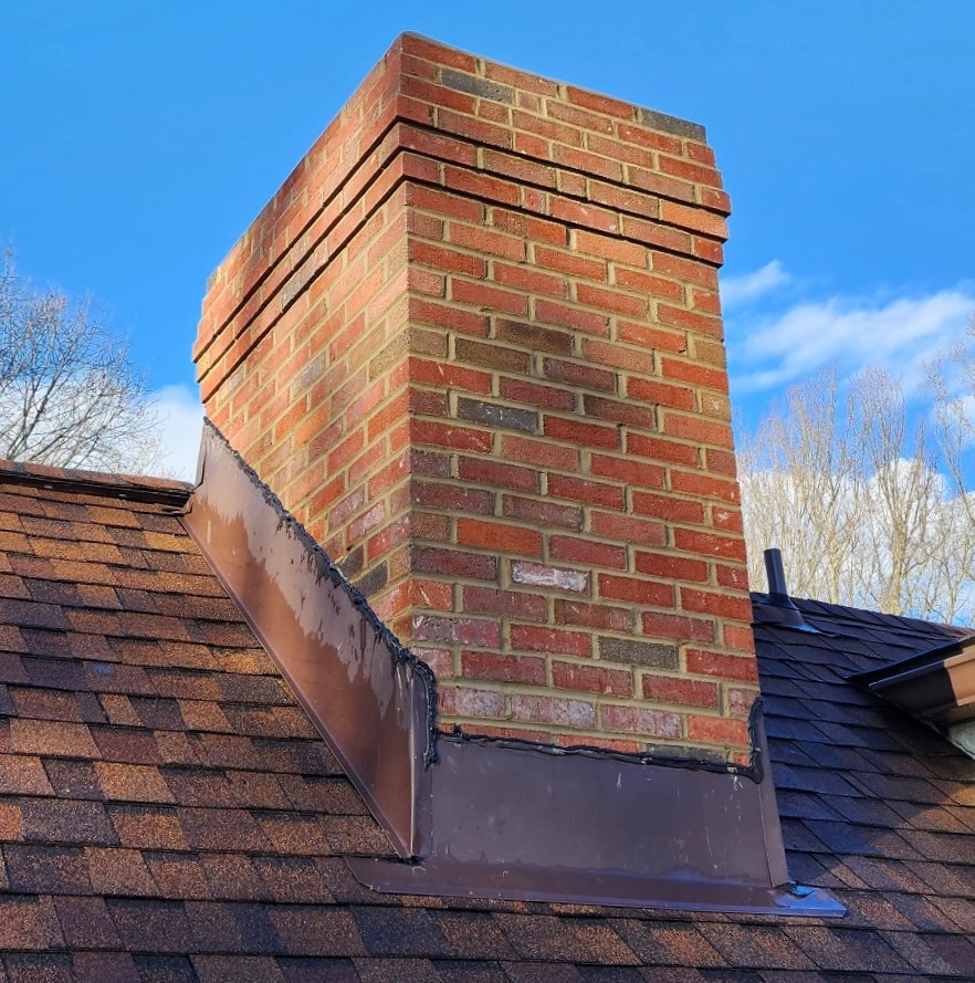Brick chimney on a roof